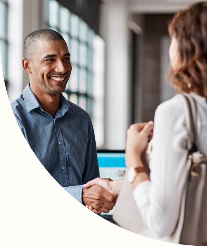 young businessman shaking hands with a woman in an office