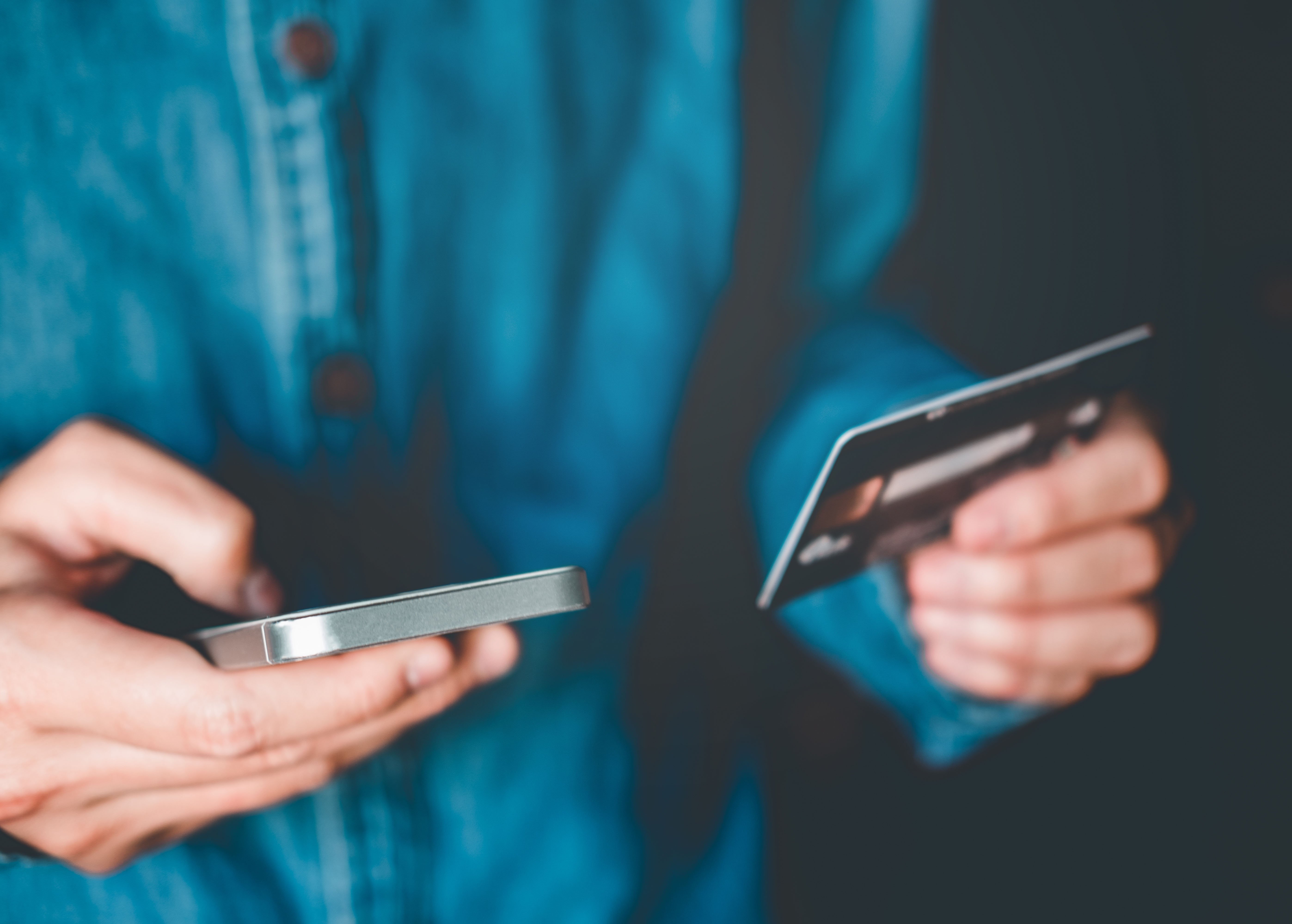 Man holding phone and credit card