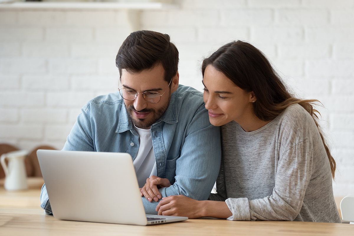 couple looking at laptop image