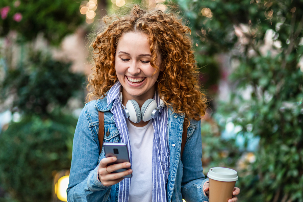 Lady smiling at phone image