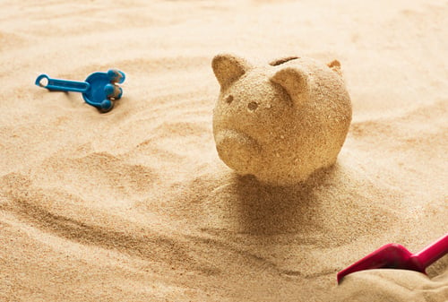 Biggy bank in the sand image