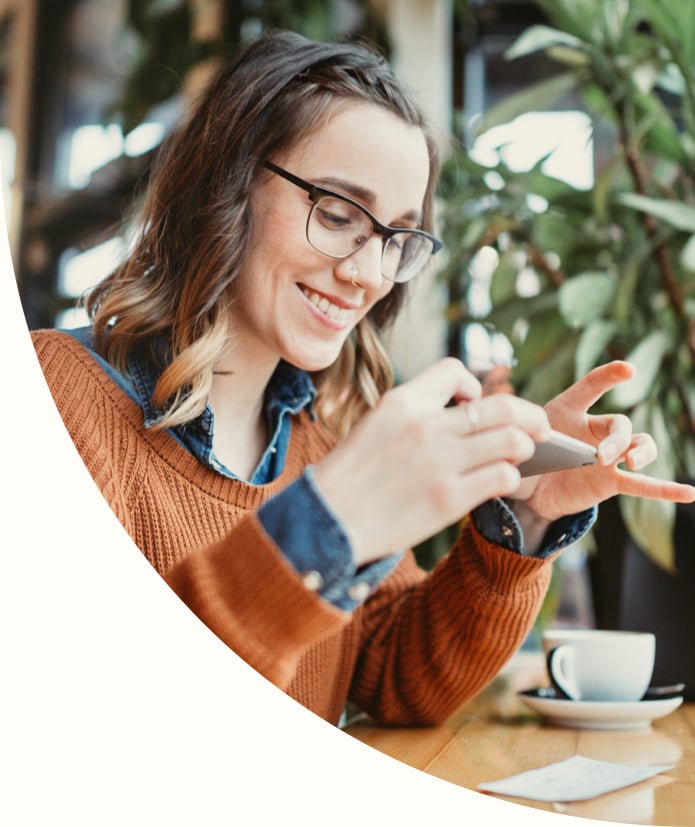 A woman taking photo with smart phone of a check for digital electronic depositing, also known as 