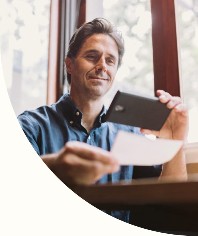 Man performing remote deposit capture on phone
