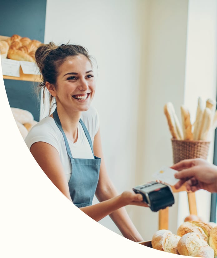 Customer making a credit card payment in a bakery
