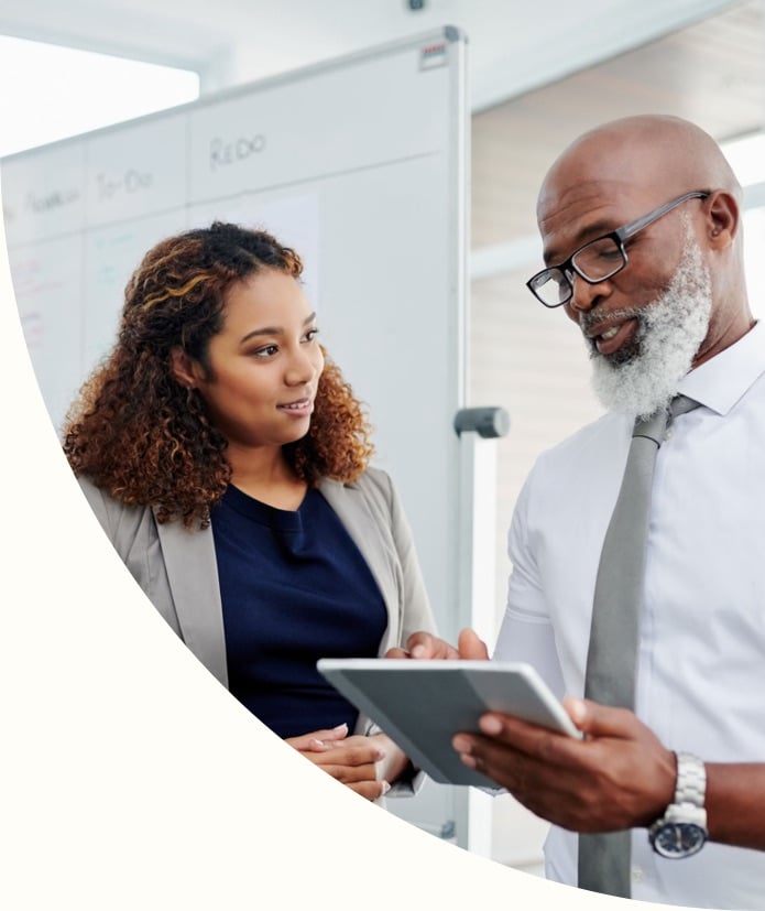 Bussinesswoman explaining business plan on tablet to colleague