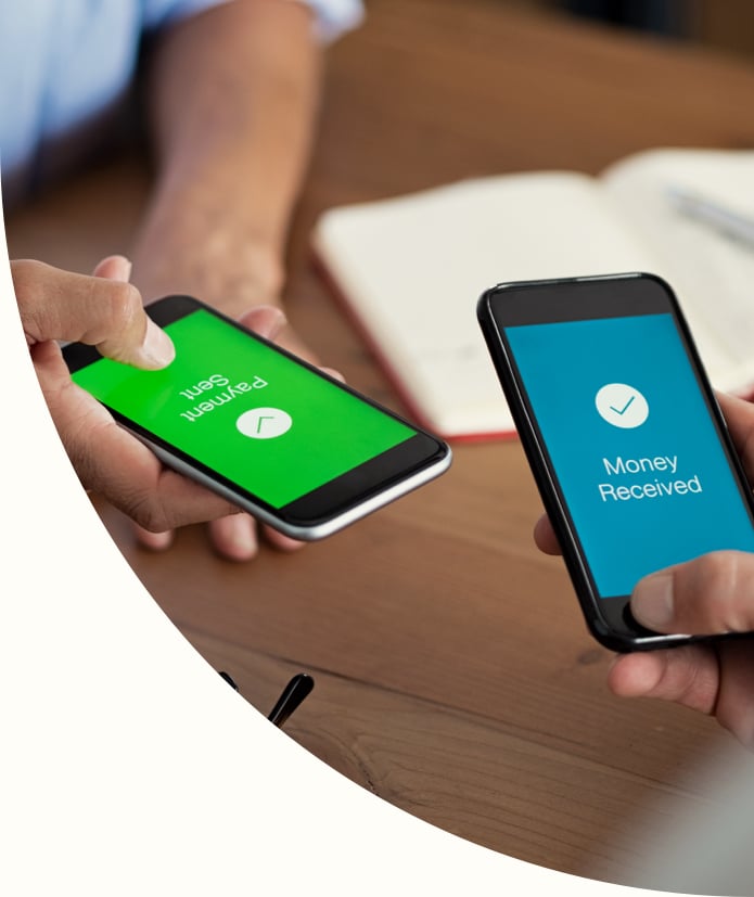Man and woman holding smartphones and making payment transaction