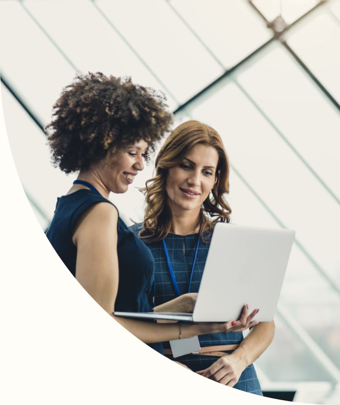 Two Businesswomen Working in The Office, Using Laptop