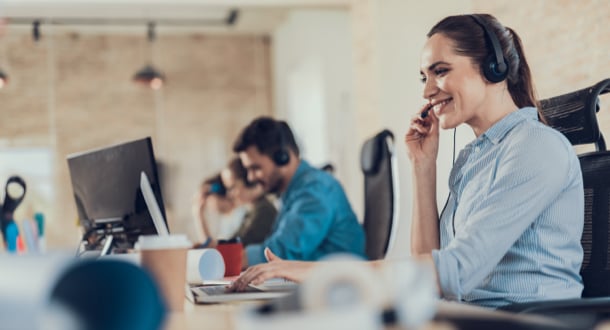 lady sitting in call center while using headset and talking