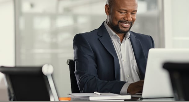 Businessman working on laptop in modern office