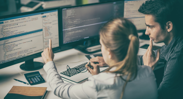 Coworkers analyzing information on computers