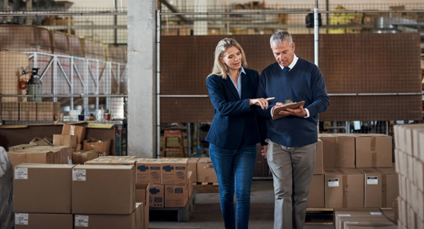 two factory managers working together in a warehouse