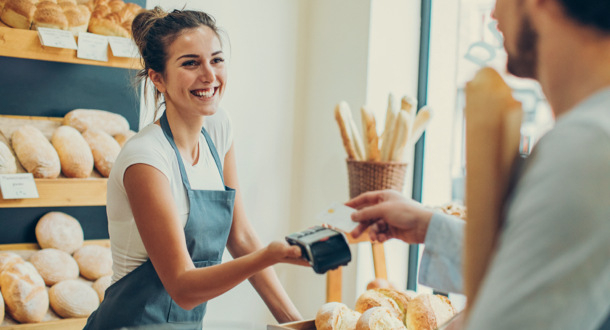 Customer making a credit card payment in a bakery