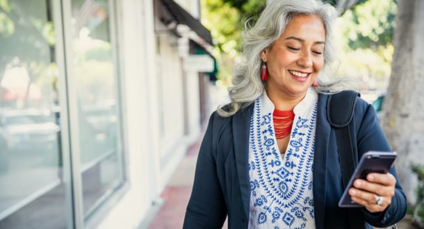 mature businesswoman on phone managing account