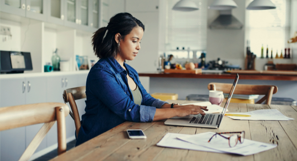 young woman using a laptop while working from home