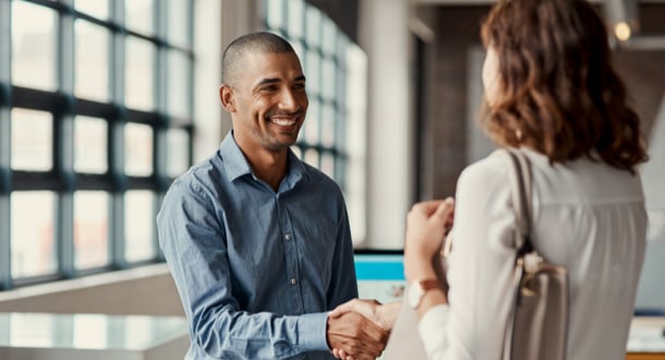 a young business man shaking hands with a business woman