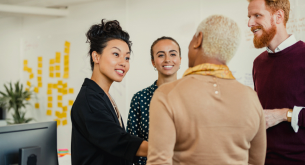 Colleagues standing in a small group having a discussion