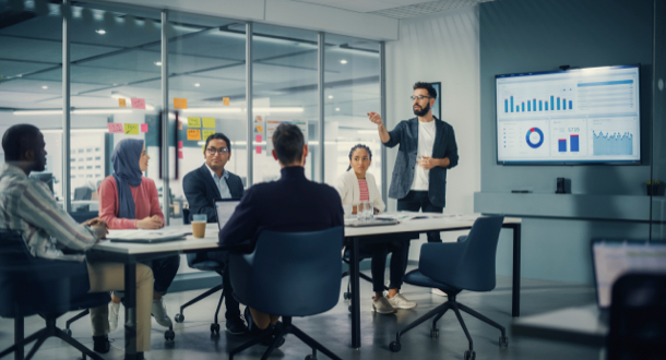 male giving presentation to office room