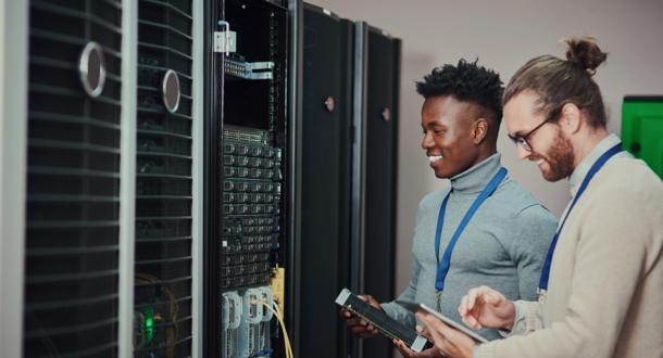 two young technicians using a digital tablet in a server room