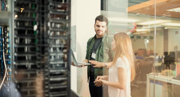 Colleagues discussing in office server room