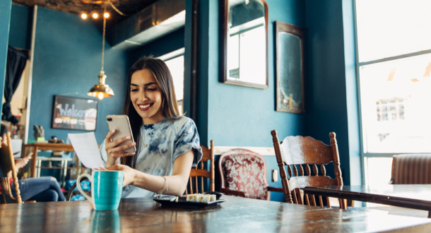 Woman taking a picture of restaurant receipt