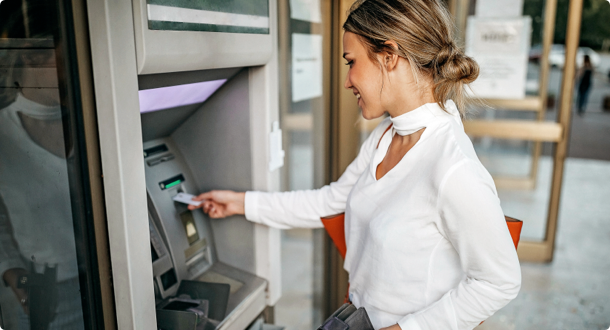 Woman using ATM machine to withdraw money