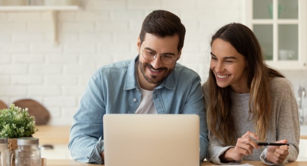 young couple planning budget on computer