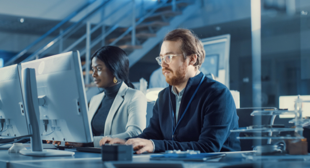 male and female at computers performing disaster preparedness services