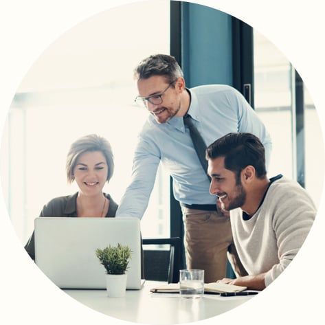  group of businesspeople using a laptop during a meeting