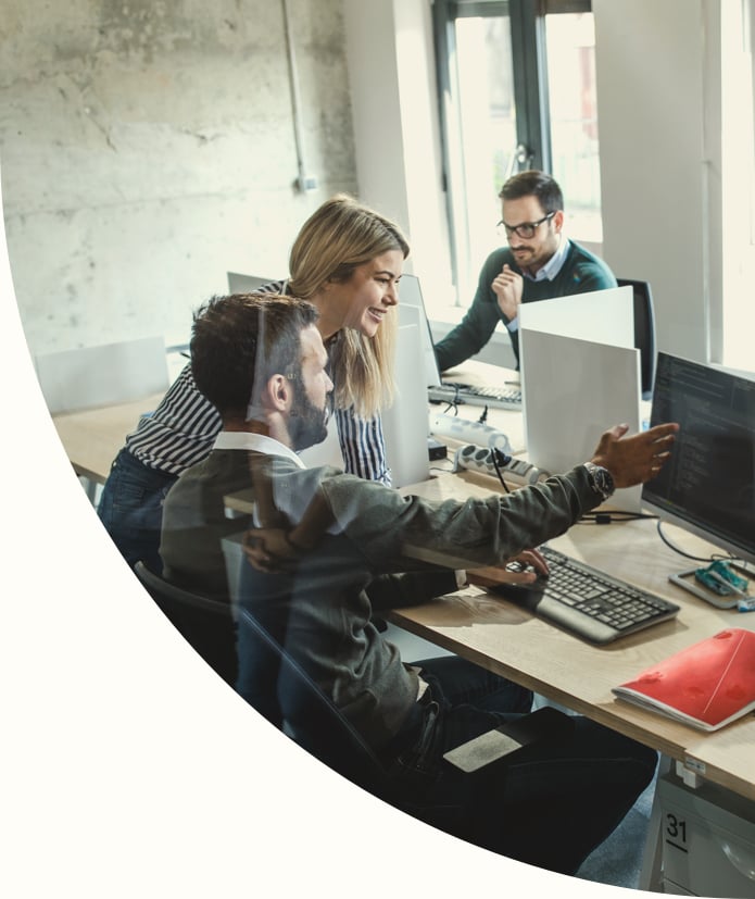 group of computer programmers working in the office discussing solutions