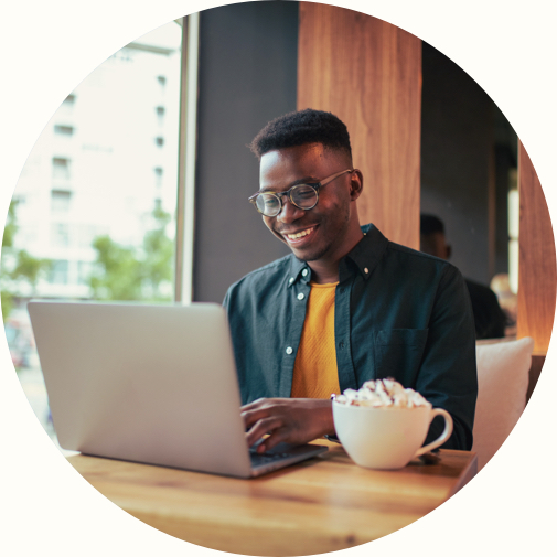 african american male at coffee shop working on laptop