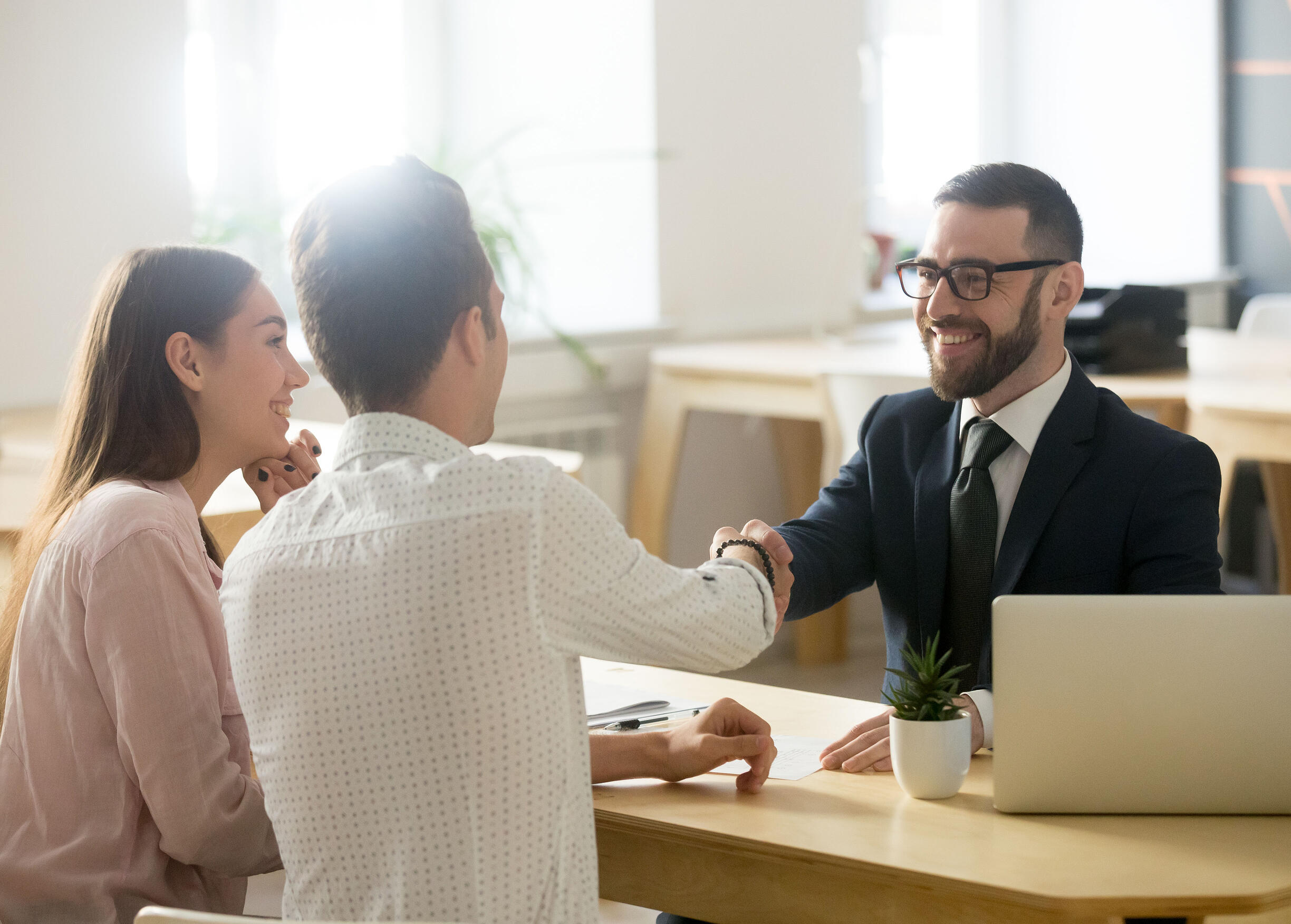 couple shaking hands with advisor