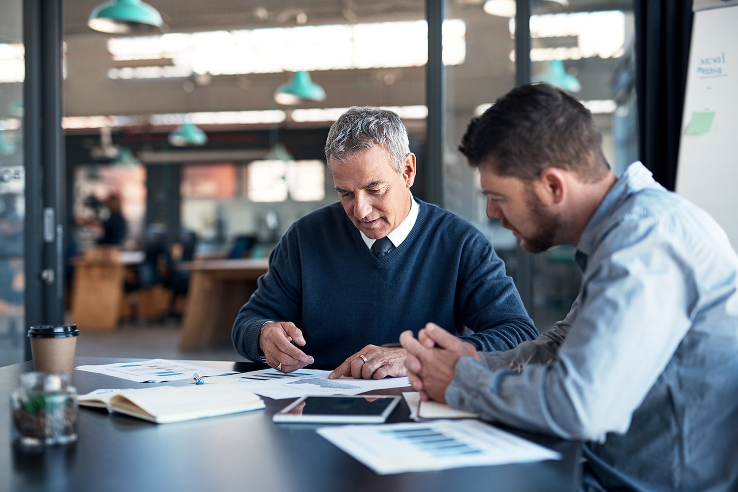 Two businessmen having a focused discussion in a meeting room in a modern office