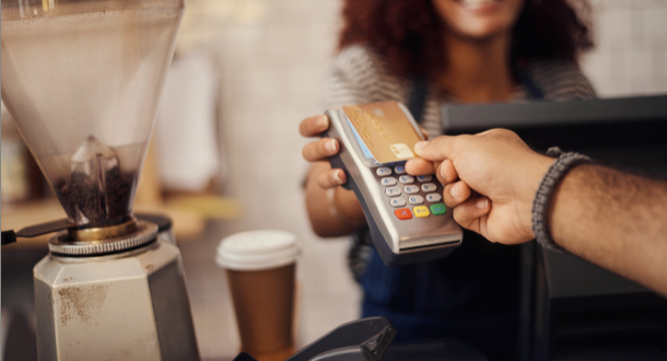 Closeup shot of a customer making a credit card payment in a cafe