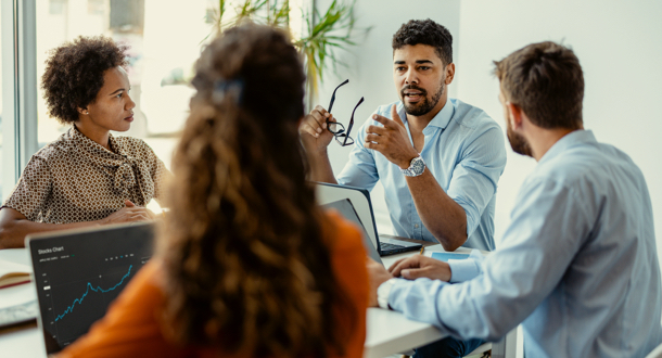 Group of young modern people in smart casual wear discussing the technology ecosystem