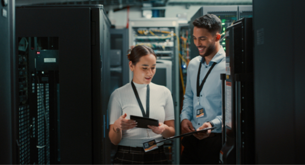  two colleagues working together in a server room