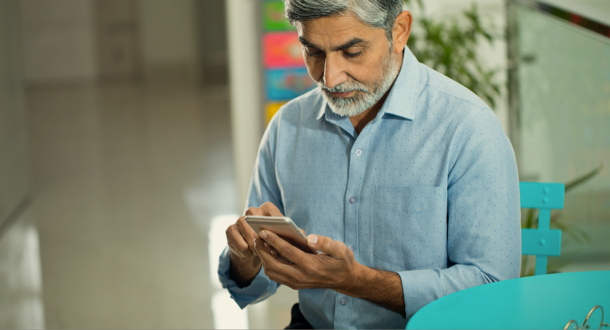 Mature businessman looking at mobile phone 
